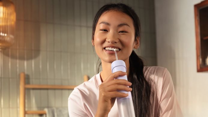 Philips Іригатор Philips портативний Sonicare Compact Flosser 1000, чаша 200 мл, складний, фіолетовий HX3333/23 фото